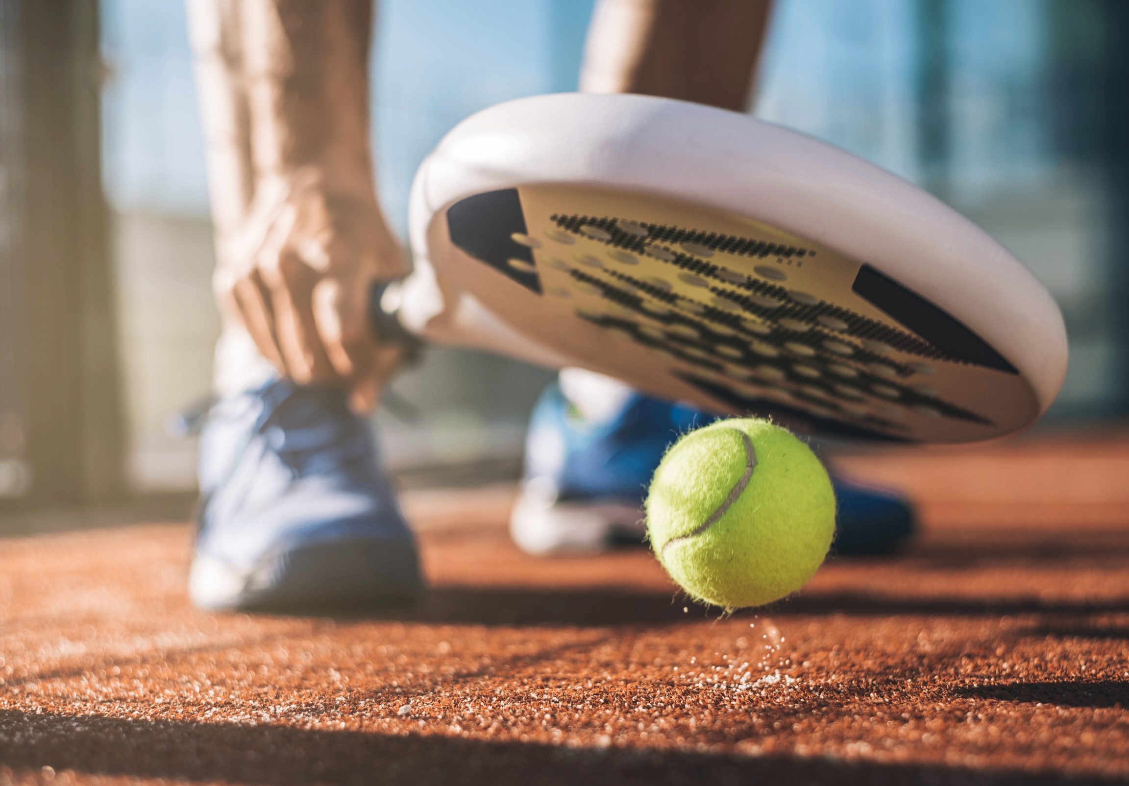 A person is holding onto a tennis racket